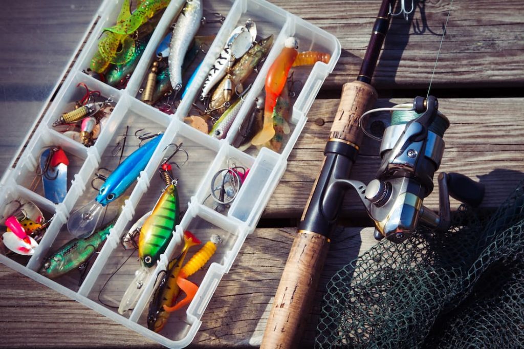 Tacklebox with bass lures and a spinning rod and reel