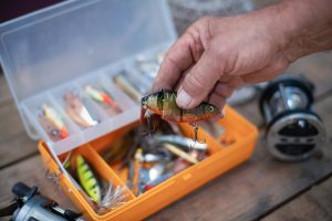 Man holding a fish shaped lure