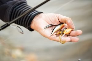 Man holding fishing lures