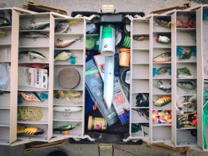 Open tackle box full of winter bass lures