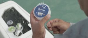 man holding a roll of fishing line