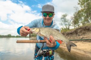 Man holding up a fish he caught