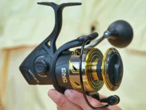 Man holding up the Penn Battle 2 reel.