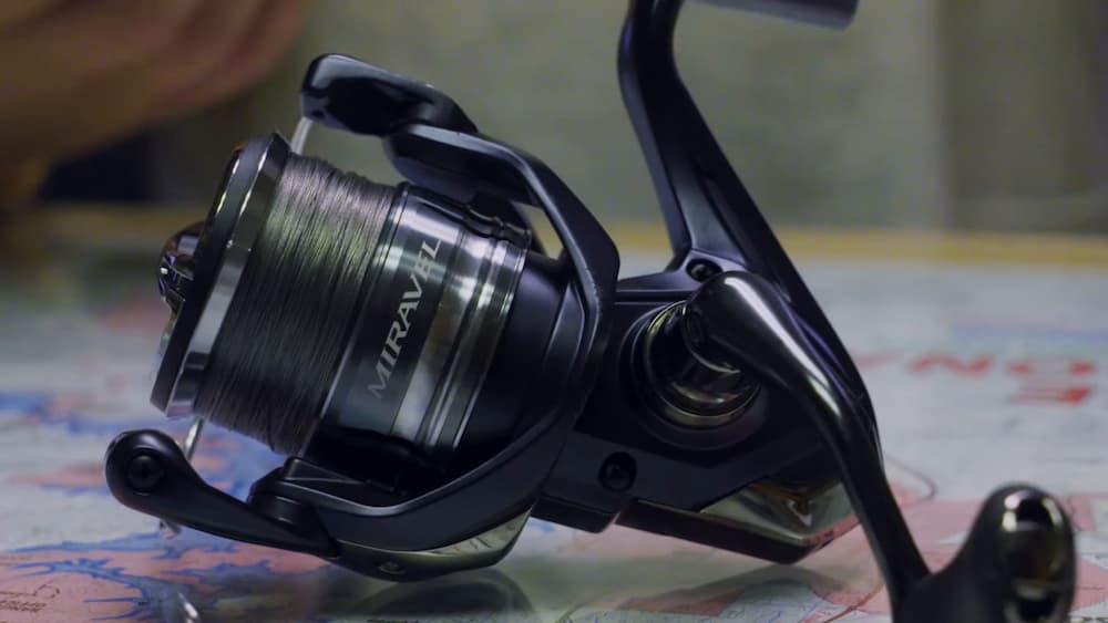 Shimano Miravel spinning reel sitting on a table.