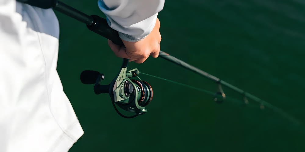 Aperson showing off the Abu Garcia Zata Spinning Reel.