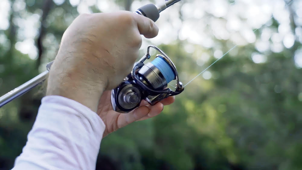 Icy blue Daiwa Certate LT Spinning Reel in hand.