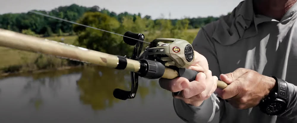 A person holding a bass fish caught during cold front conditions