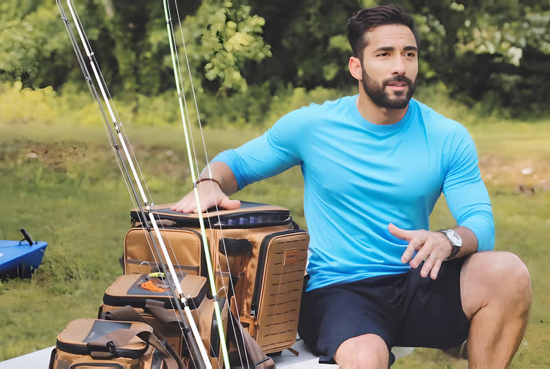 A man fishing with a fishing pole, utilizing the Plano Guide Series Tackle Bag for his fishing equipment storage