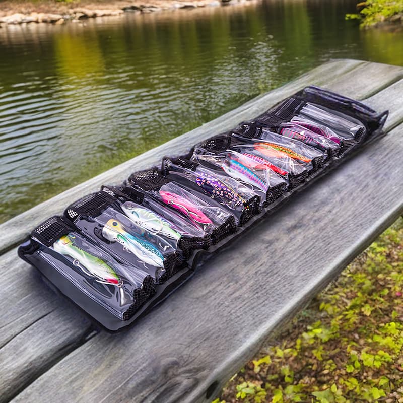 Nomad Design Lure Roll showcasing a row of fishing lures on a wooden bench