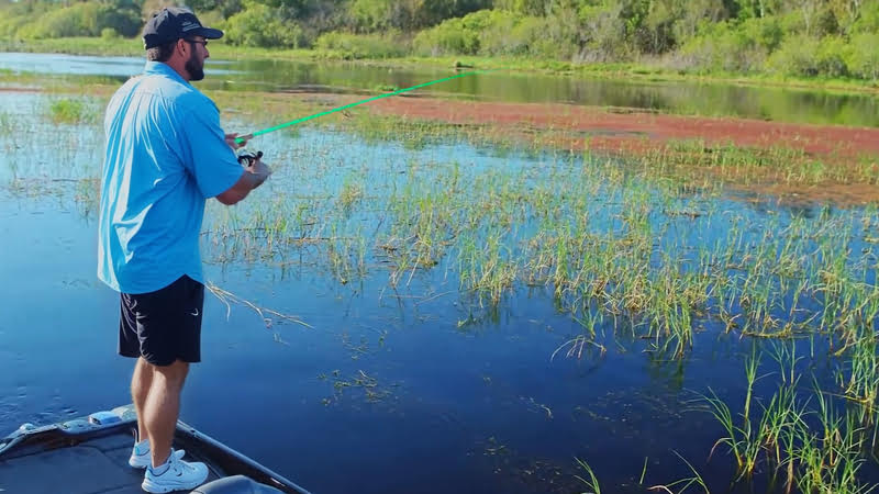 A man fishing with a drop shot rig from a boat