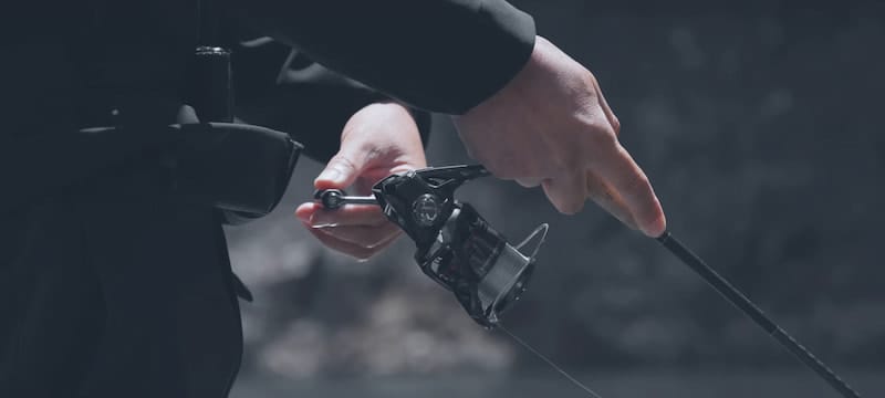Angler reeling with Shimano Vanford spinning reel on a cork-handle rod